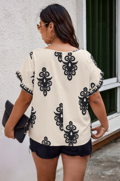 Plus size beige printed blouse with wide round neckline and ruffle hem