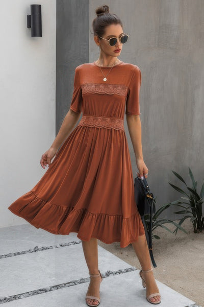 Rust-colored Midi Dress with lace trim, round neckline, and flowy ruffle hem